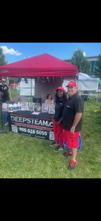 Grant Brennan at the DeepSteam.ca booth under a red canopy at a community event