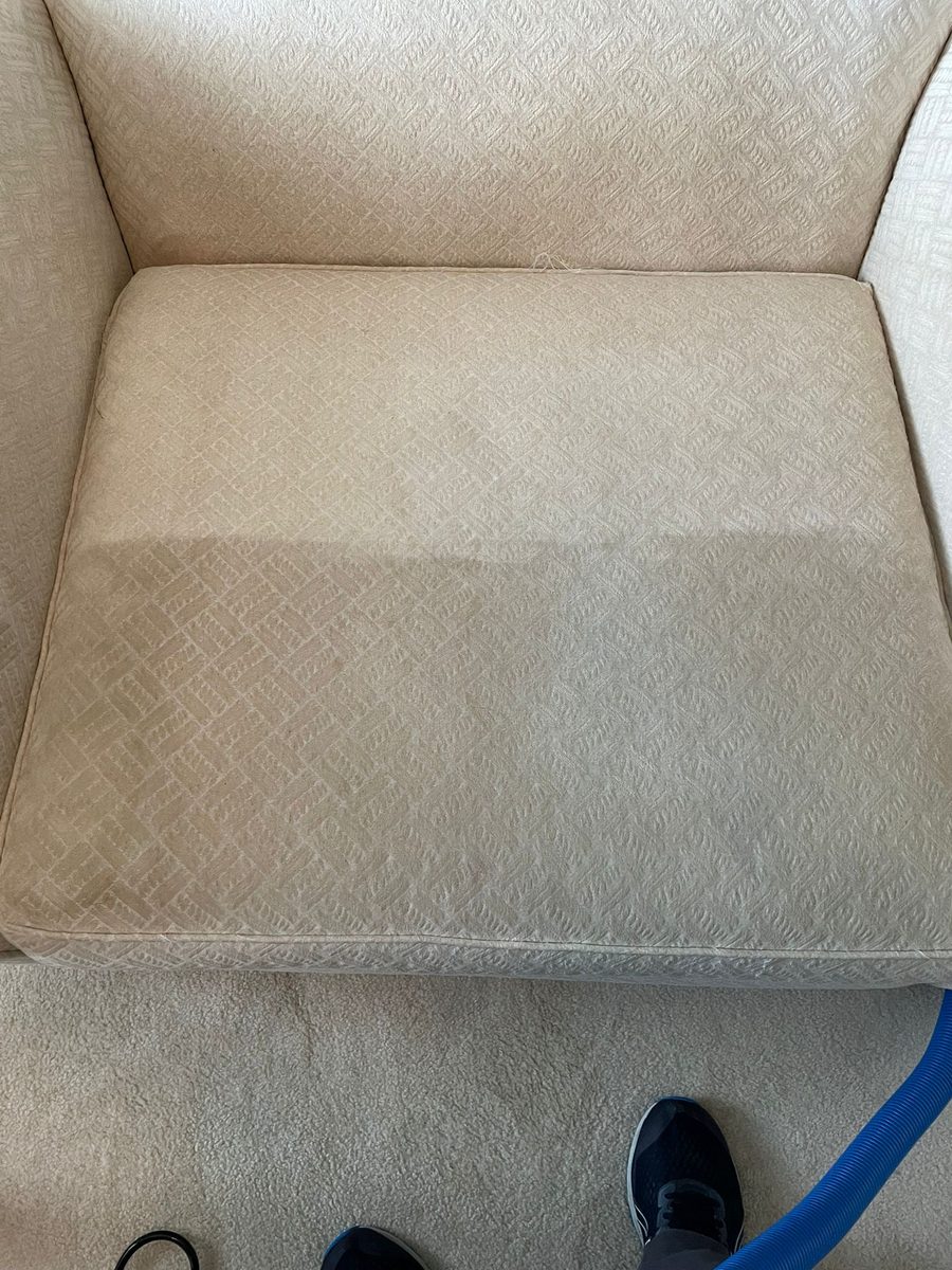 Cream armchair seat cushion with the back half cleaned and the front half still greyed